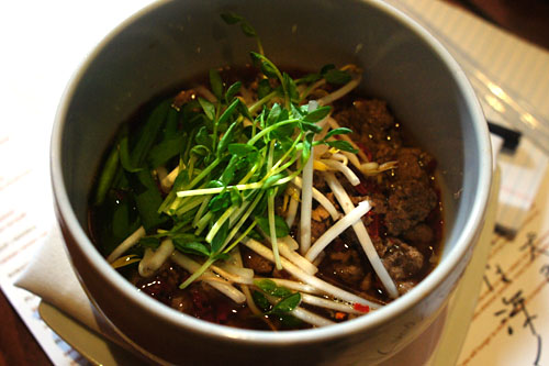 Taiwan ramen noodle, Nagoya style spicy noodle soup served with beef and pork, Asian chives, and dried red chili