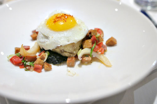 Berkshire pork trotter, cuttlefish, andouille sausage, piquillo peppers, black garlic grits, sunny side egg