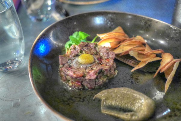 ma la beef tartare, pear, pine nuts, quail egg, bone marrow vin