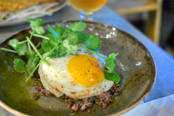 bhutanese red rice, dungeness crab, lamb bacon, fried egg