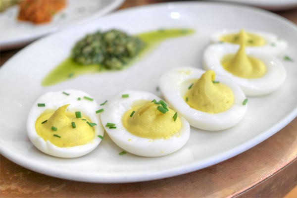 Deviled eggs with green sauce