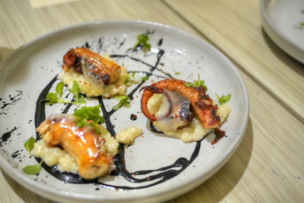 Octopus with Koshihikari rice, sauce nero, lardo and espelette 