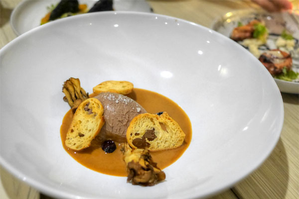 Chicken liver mousse with mushroom, hazelnut praline, pickled blueberries and toast