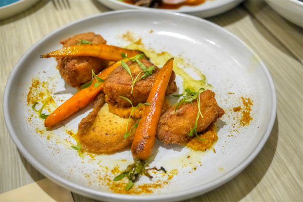 Crispy chicken thigh with steelcut oats, carrots, pickled dates and Moorish spices