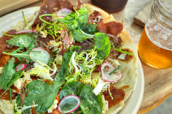 Blue crab quesadilla with Oaxacan cheese, summer squash, farmer market greens, guajillo chile, radish, lime