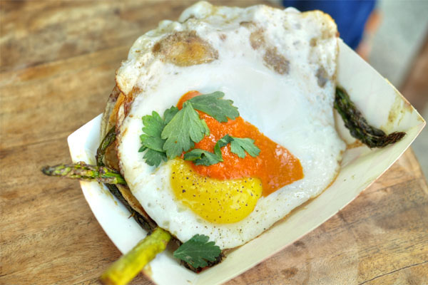 Pencil asparagus and fried egg taco with almond, chile, cashew, parsley