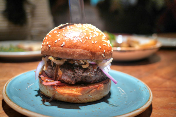 Dry aged burger, onion 7 ways, sesame brioche bun