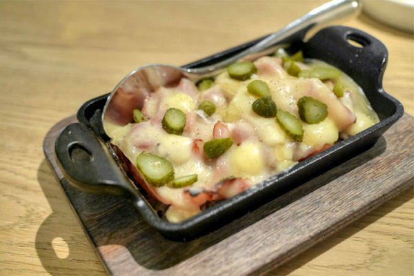 melted raclette with weiser potatoes, ham, cornichon, & mustard