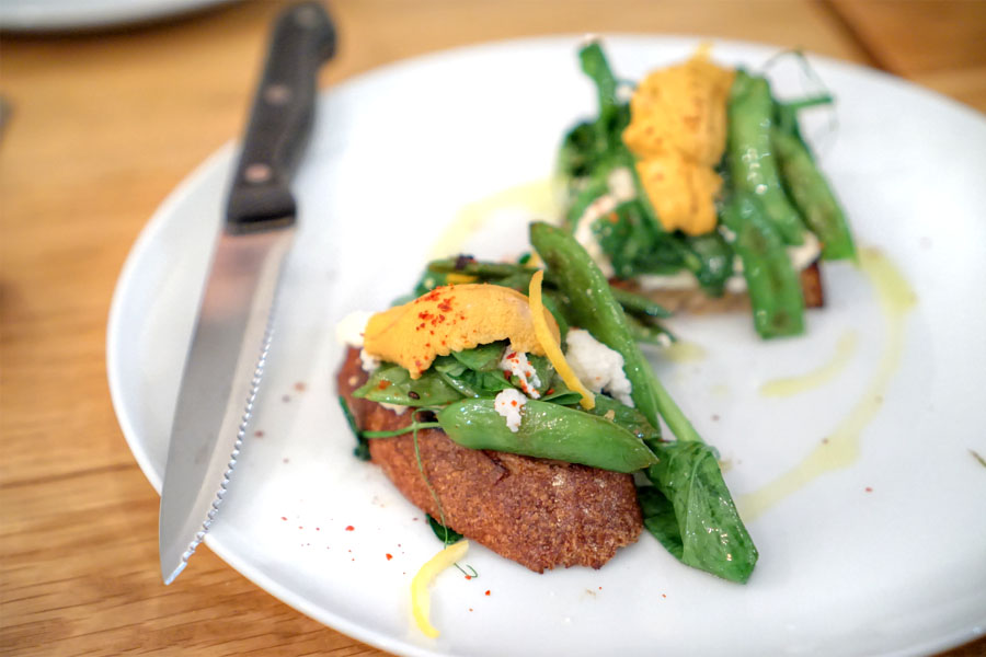 sea urchin toast with spring peas, ricotta, and preserved lemon