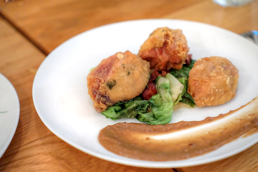 fried chicken thigh with cornbread puree, escarole, bacon, and red eye gravy