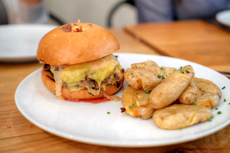 burger, caramelized onion, american cheese, B&B pickles, 1000 island, and fried fingerlings