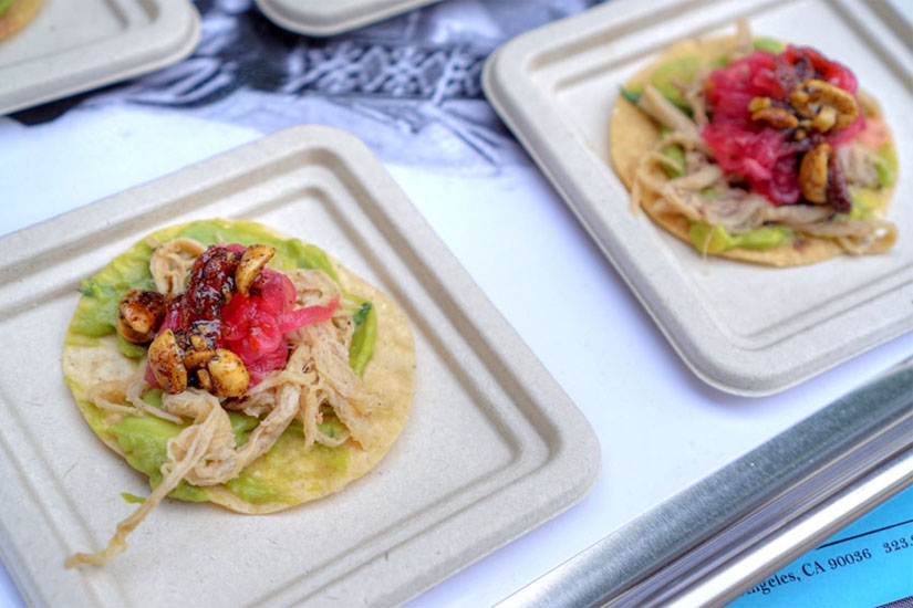 Pork belly tostadita, corn tostada, guacamole, pork belly, pickled red onions, roasted peanut sauce