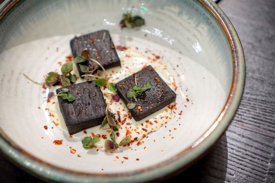 Black garlic-chickpea fritter with yuzu and Aleppo pepper