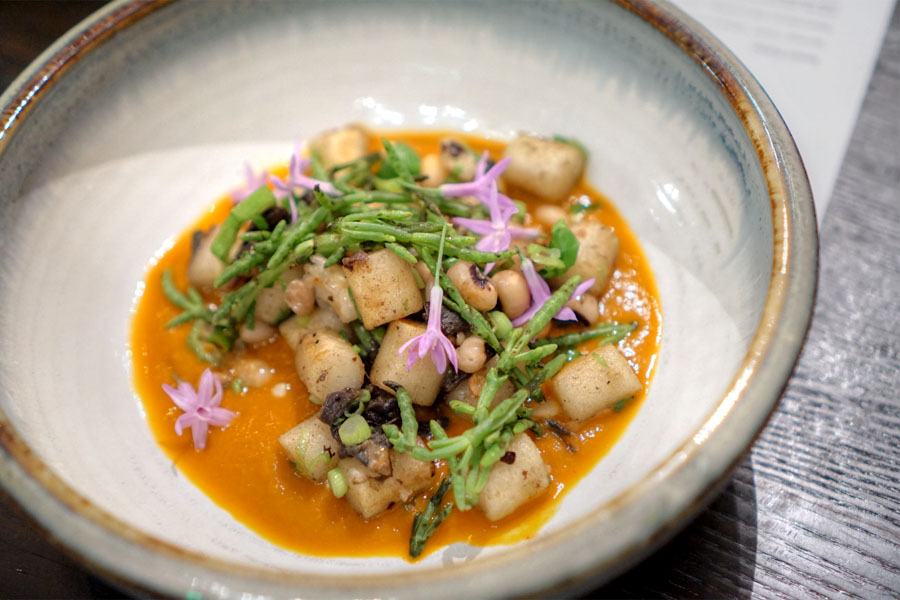 Rice cake 'gnocchi' with shelling beans, okra, sea beans and tomato-kimchi soup