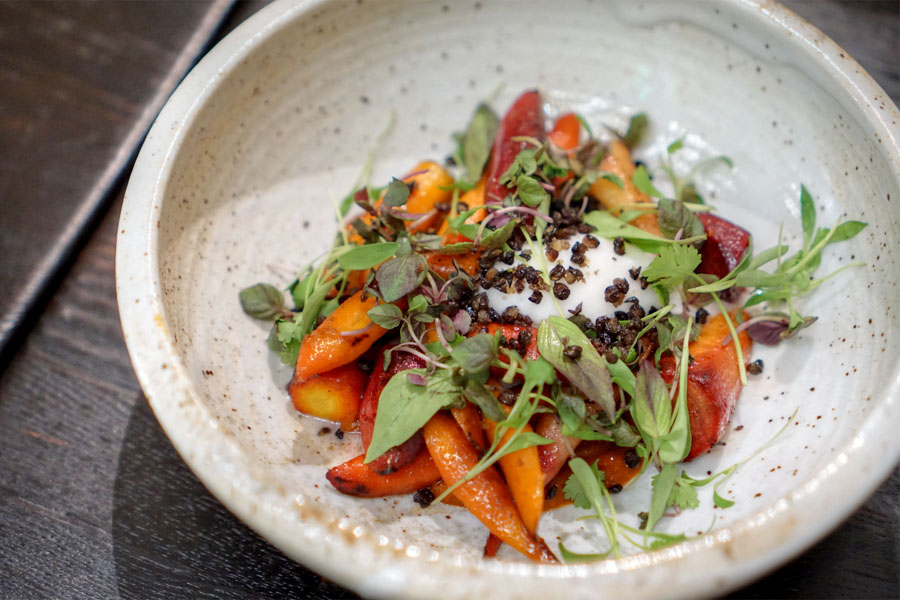 Roasted carrots with coconut, crispy lentils, Thai herbs and tamarind sriracha