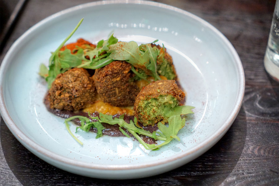 Bitter greens falafel with apricot-ginger mostarda, dried olive and smoked paprika