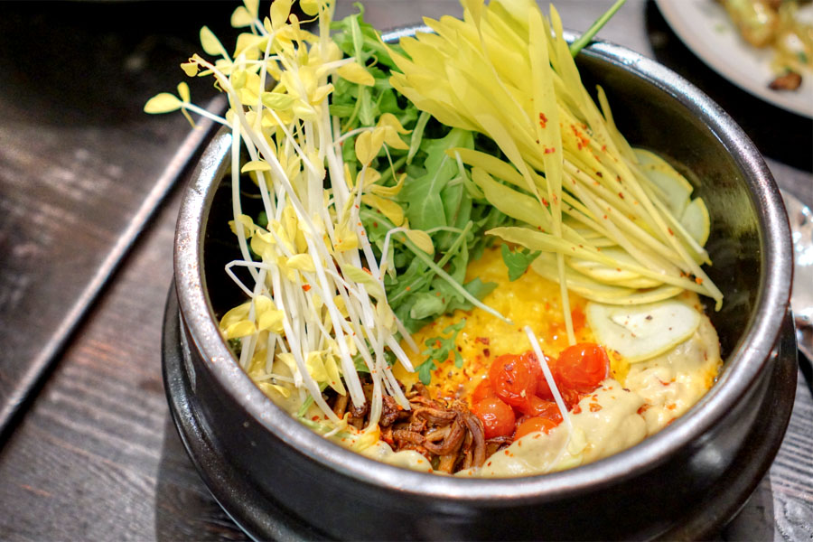 Saffron rice 'hot pot' with tomato adobo, summer squash, arugula and fennel-peach sofrito