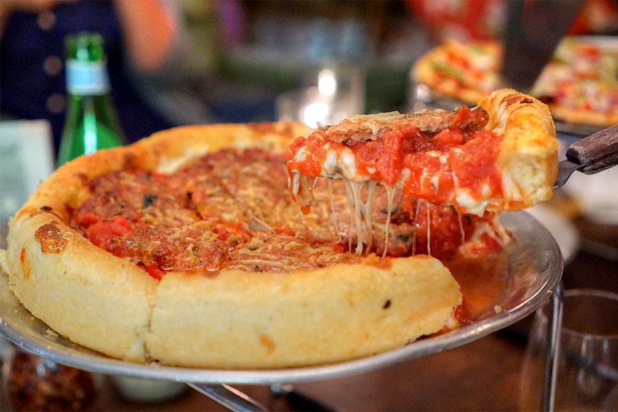 Small Traditional Deep Dish Pizza (Lifting a Slice)