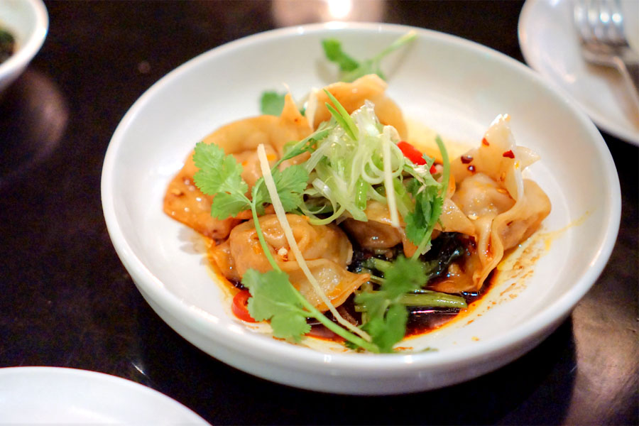 pork, shrimp, & crab dumplings, spicy black vin dressing, chives, spinach, peanuts