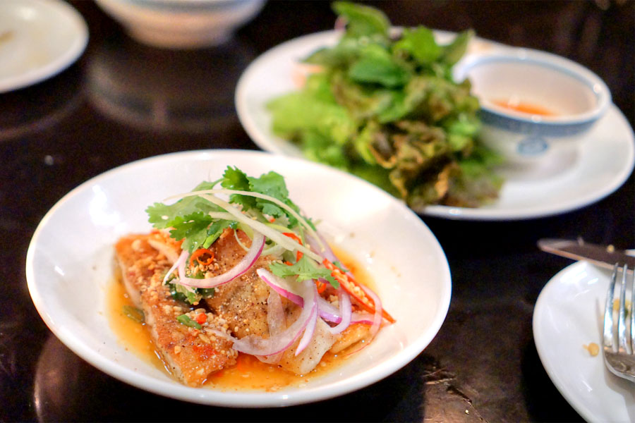 fried sea bass, scallion oil, peanuts, herbs, ginger chili sauce & fresh lime