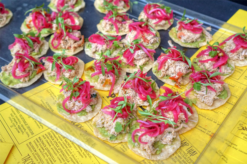 Chicken Machaca Tostadita with Bell Pepper, Tomato, Roasted Peanut Sauce, Guacamole, and Pickled Onions