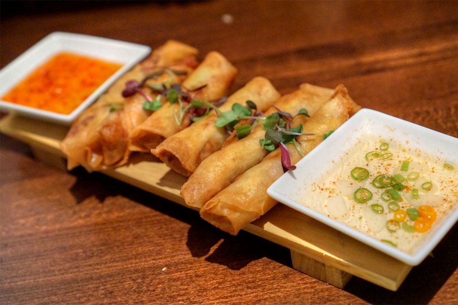 Lumpia, hand made Filipino eggrolls, ground pork, market vegetables, garlic vin, sweet & spicy sauce