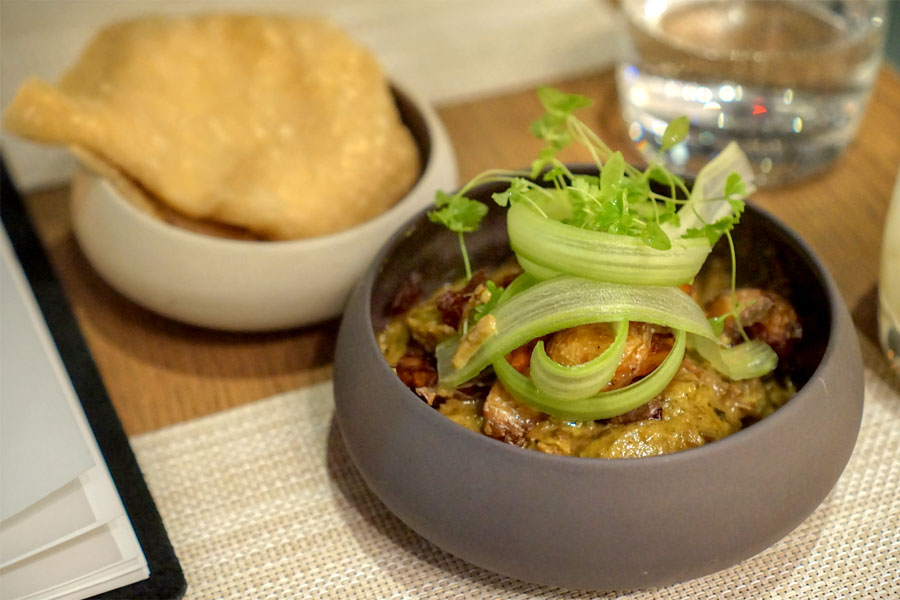 Goat roti, curried goat, crispy potatoes, dahl puri roti