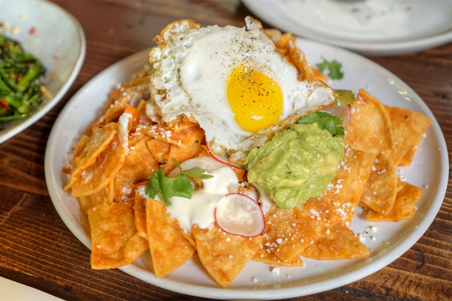 Chilaquiles, crema, fried egg, pickled jalapeño, avocado, radish