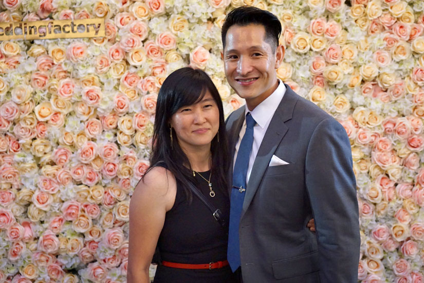 Couple in Front of Flower Wall