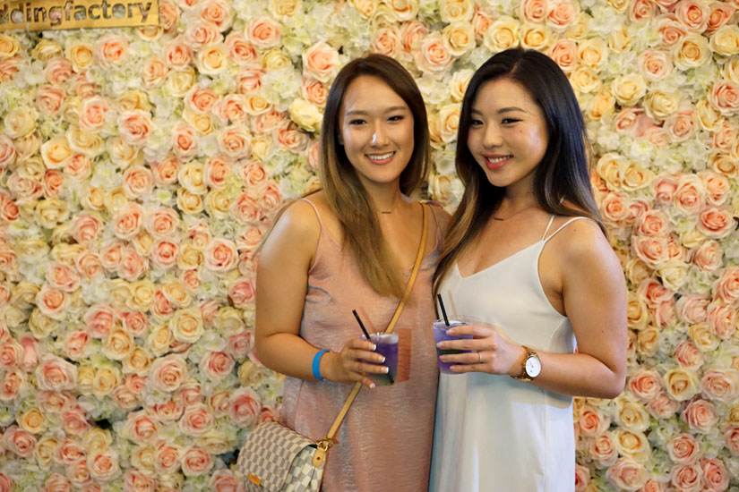 Two Girls in Front of Flower Wall