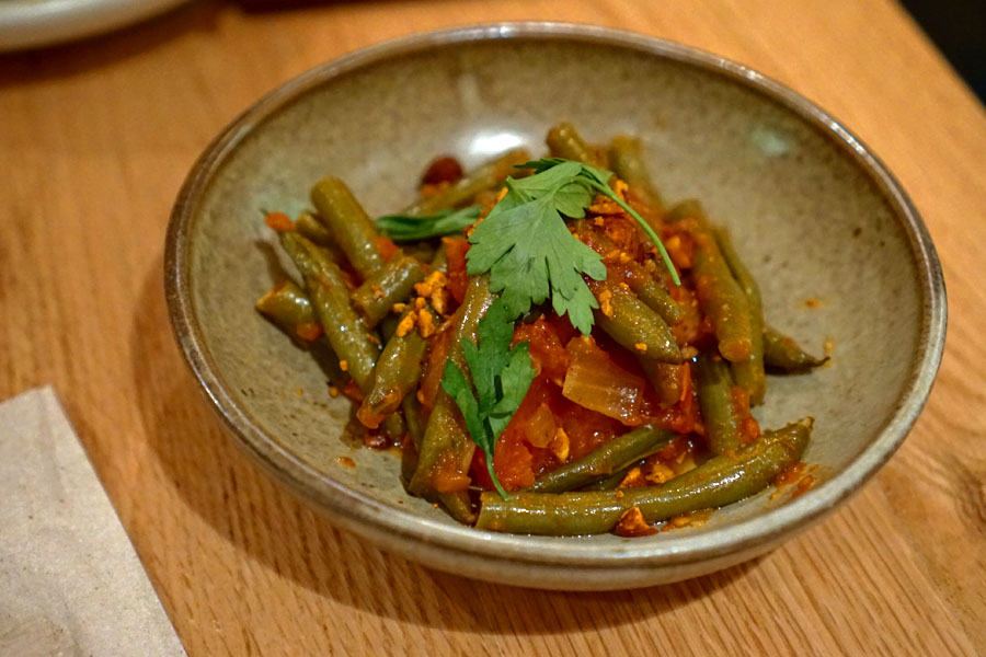 Green beans simmered in spicy tomato sauce