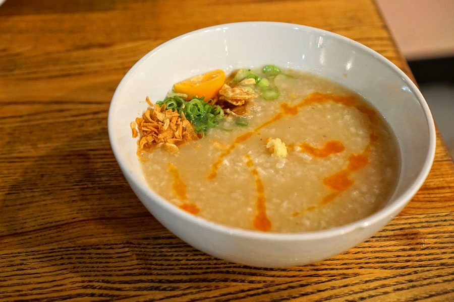 Arroz caldo, rice porridge, fried garlic, chicharron, chile oil, ginger