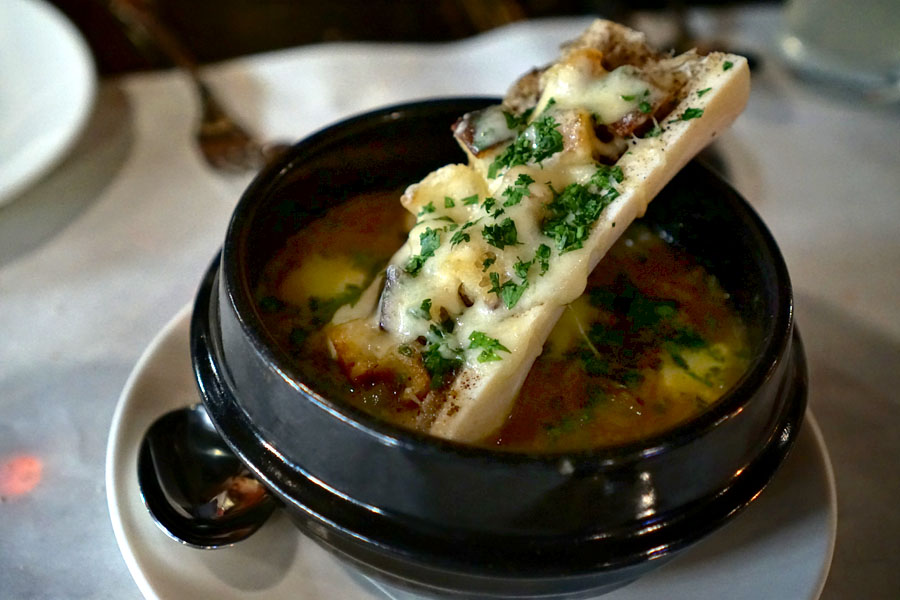 Soupe à l'oignon, French onion soup, bone marrow, raclette, chopped parsley