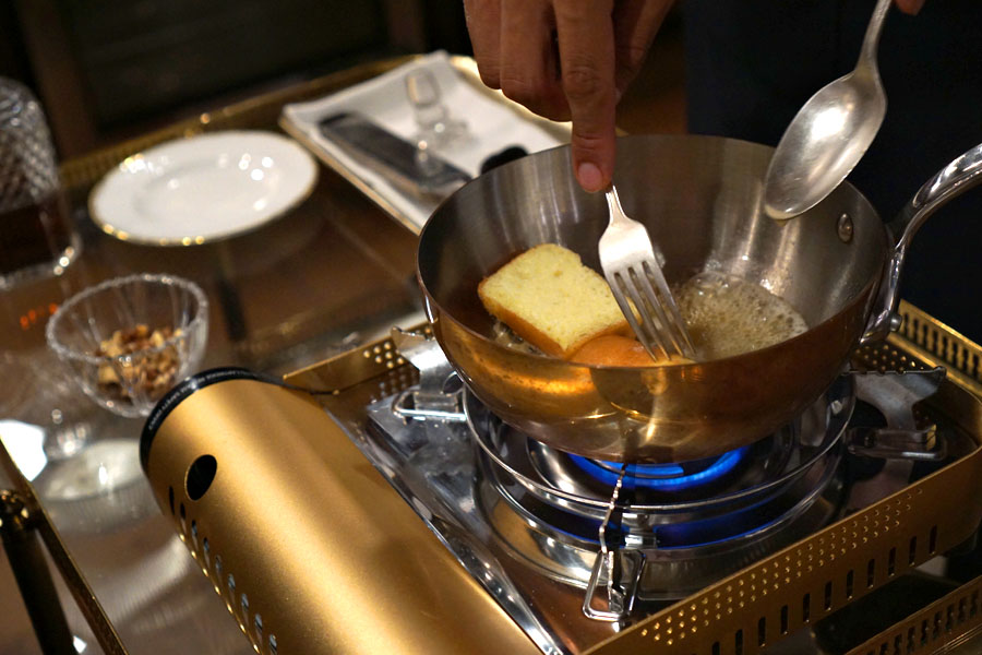 Tableside baba au rhum preparation