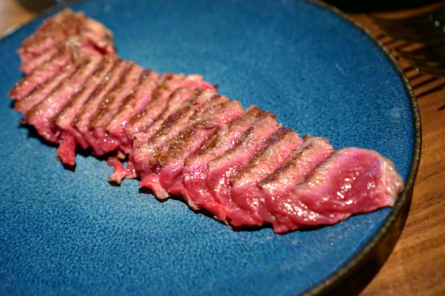 New York Strip cooked over the wood fire