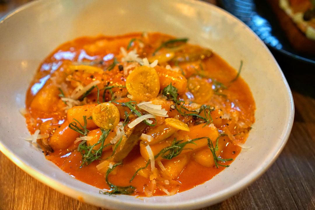 Rosé tteok (Tokki) bokki, fried rice cakes with rosé gochujang sauce, oyster mushrooms, manchego, perilla leaves