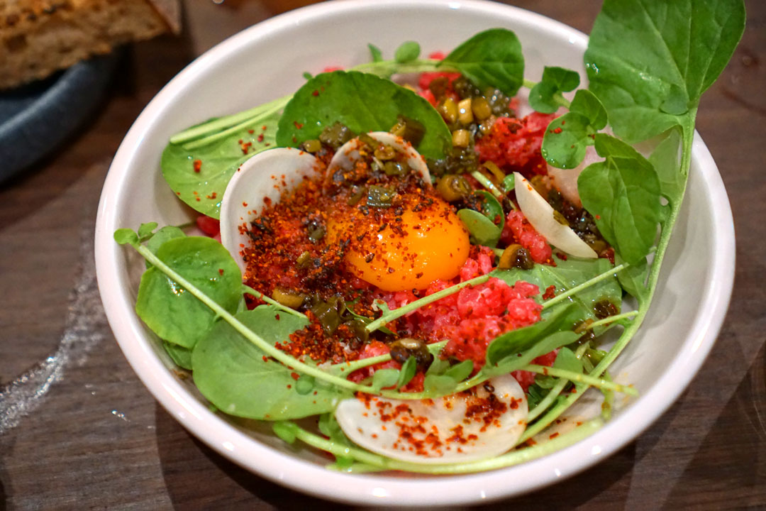 Steak tartare, red chili, scallions, tamari, yolk, turnip.