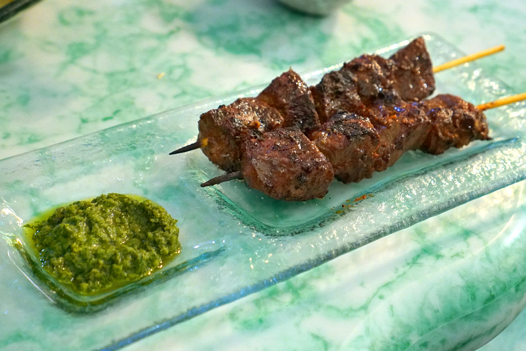 Anticucho, Peruvian street style marinated beef heart skewers with cilantro & serrano chili sauce