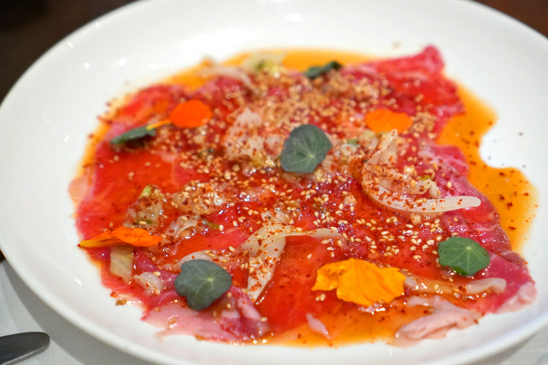 sirloin carpaccio, savoy cabbage, sesame, kochukaru