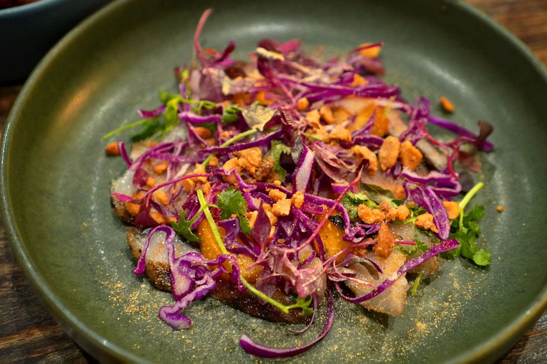 Pork jowl, red cabbage, serrano, cilantro, amaranth, peanuts, peach