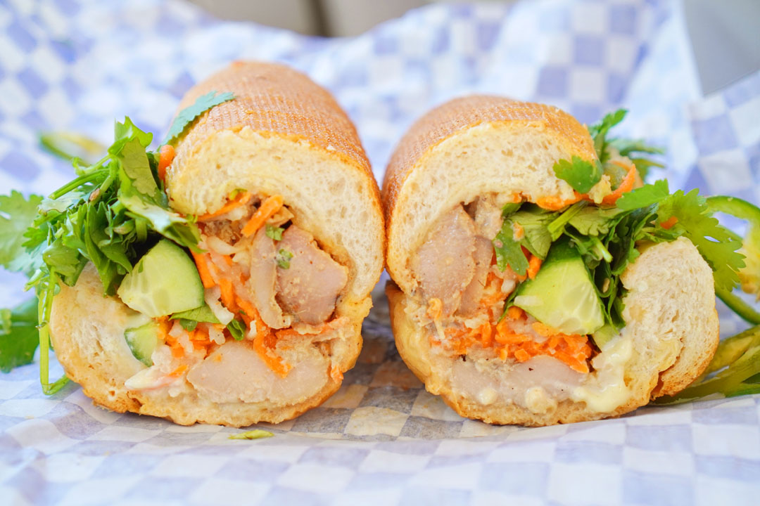 Bánh mì sandwich - lemongrass chicken, patê, aioli, pickled radish & carrots, cucumbers, jalapeños, cilantro