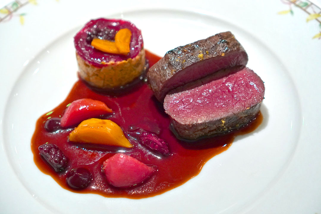 Grilled loin of venison flavoured with timut pepper, medley of beetroot and blackberries, red wine sauce