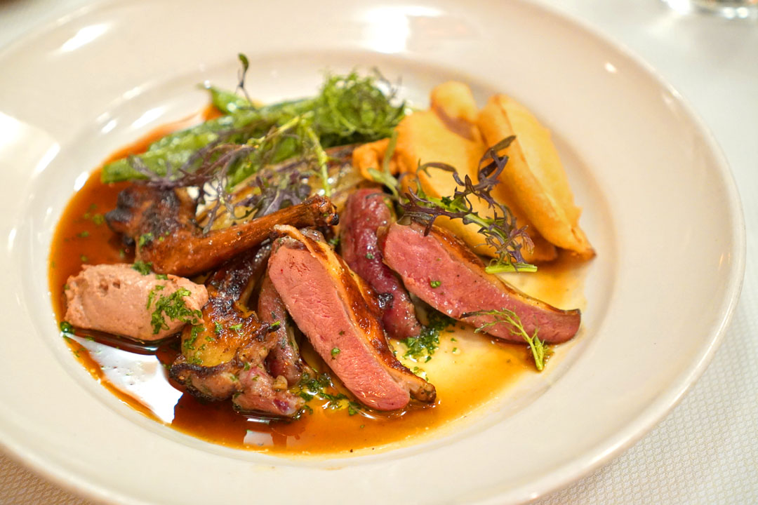 Paine Farm squab grilled with thyme and garlic; with eggplant fritters, roasted red torpedo onions, and romano beans