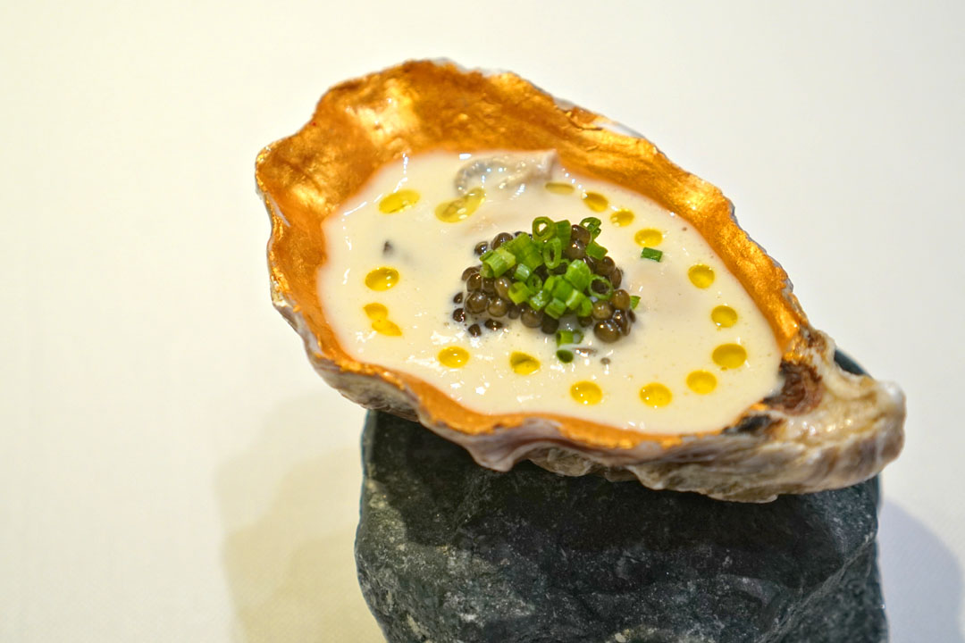 Fire-grilled oyster with a smoked seafood velouté