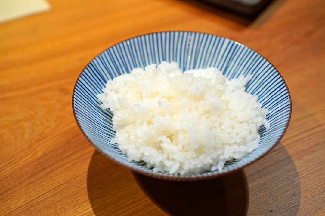 steamed rice in an iron pot